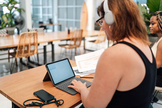 Senior woman explores tablet features, embracing lifelong learning and adaptability in the digital age.