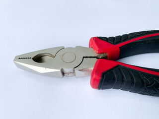 Pliers in red and black colored on a wihte background with blank text space.