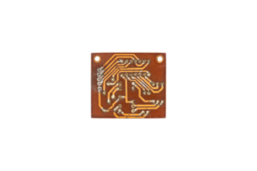 Old small electronic circuit board with copper tracks is isolated.