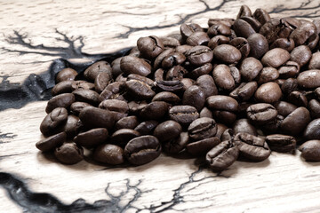Coffee beans on the dark wooden background