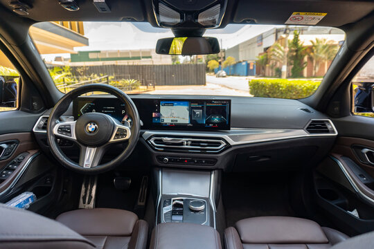 BMW 320i full interior cockpit with large curved display, High-tech luxury sedan dashboard

