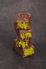 Dubai chocolate candy with crispy kataifi and pistachio paste. Close up. Dark background	