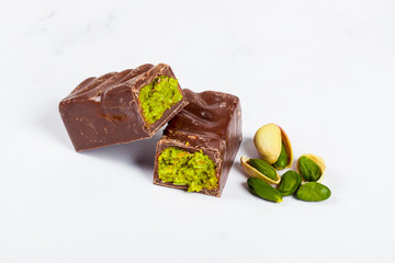 Dubai chocolate candy with crispy kataifi and pistachio paste. Close up. White background