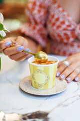 Small container of colorful and fruity artisanal ice cream. Decorated in pastel tones.