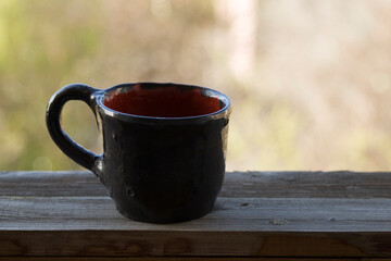 Ceramic cup on a wooden board.