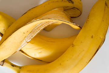 Banana peel is located on a white paper.