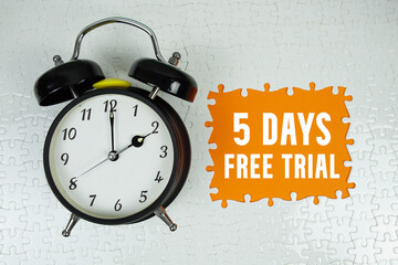 5 Days Free Trial text with alarm clock on orange background