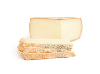 Raclette slices with cheese wheel. Fresh sliced raclette cheese. Traditional Swiss meal or French cheese dinner. Melting cheese for grill trays at the table. Selective focus. White background.