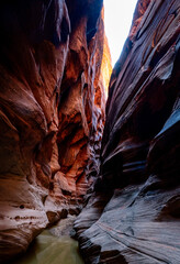 Impressive Patterns in a Colorful Slot Canyon with Bright Sunlit Peaks Above
