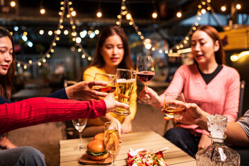 Group of Asians are having a celebration at a restaurant with drinks.