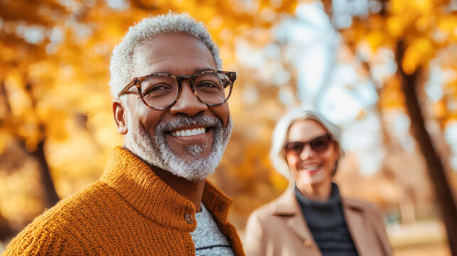 Happy multiracial senior couple having fun walking together at city park during autumn season - Fall, love and elderly people concept - Models by AI generative