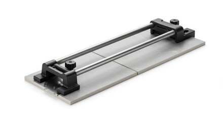 A  precision tile cutter rests on two light gray tiles, showcasing its adjustable metal guides and black components.