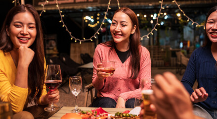 Group of Asians are having a celebration at a restaurant with drinks.