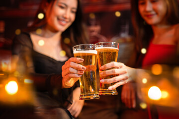 Friends having fun clinking glasses with beer