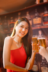  Friends having fun clinking glasses with beer