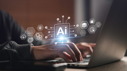 Hands typing on laptop with AI digital interface icons, representing AI business tools, automation software, machine learning analytics, and smart technology solutions for modern enterprises.