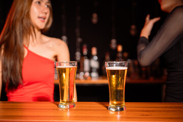 food and drink male friends are happy drinking beer and clinking glasses at a bar or pub.