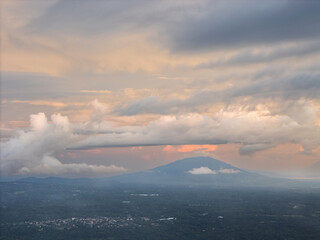 Sunset over volcanic mountains with dramatic clouds in sky