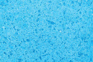 Bright blue textured surface resembling water or polished stone in a serene and tranquil setting
