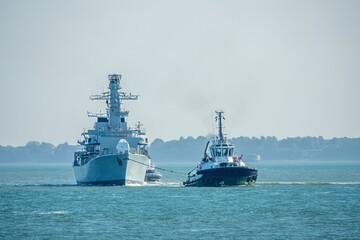 Portsmouth England - September 19 2025: decommissioned HMS Argyll F231 being towed into Portsmouth Harbour from Devenport by Tug Camperdown