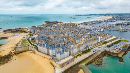 Aerial view of Saint-Malo, Brittany, France. Historic walled city on the English Channel with sandy...