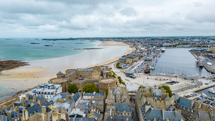 Aerial view of Saint-Malo, Brittany, France. Historic walled city on the English Channel with sandy...