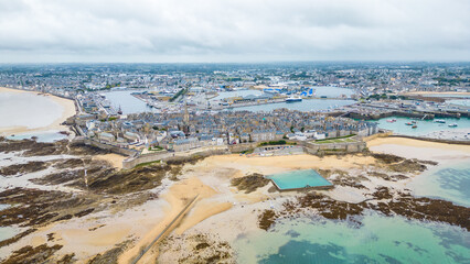Aerial view of Saint-Malo, Brittany, France. Historic walled city on the English Channel with sandy...