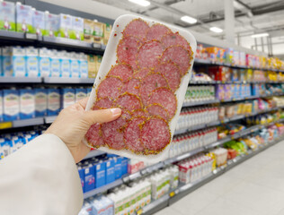 choosing  sausage and other meats at the grocery store