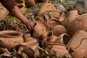 Under the Andean sun, rows of freshly shaped pottery slowly dry in Huancas, each piece hardening...