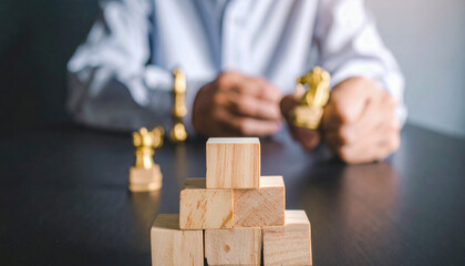 Strategic Business Planning: Building Success Steps with Wooden Blocks and Chess Pieces