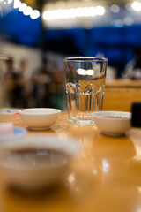 Empty glass on wood table, ready to use. Selective focus