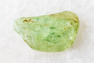 sample of rolled green kyanite rock on white
