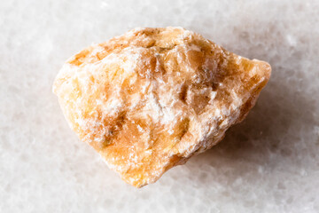 sample of uncut brown calcite mineral on white
