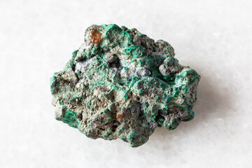 sample of raw malachite rock on white marble