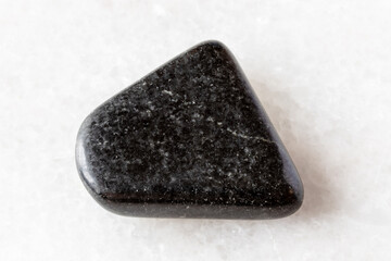 sample of polished dolerite rockon white marble