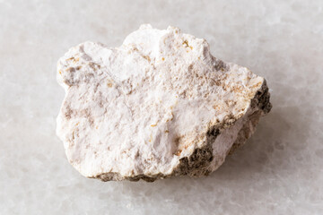 sample of rough albite rock on white marble