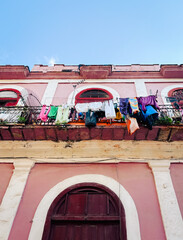 Laundry Hanging on a Pink Balcony in Havana