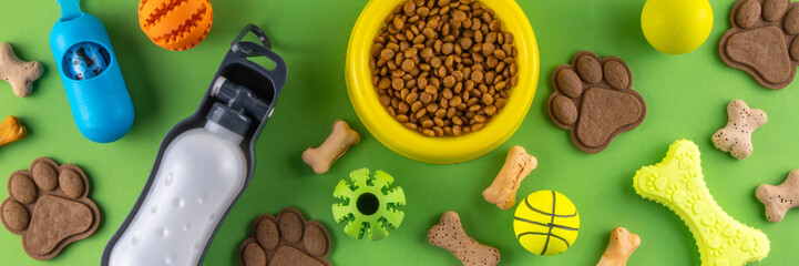 Flat lay composition with food, snacks, toys and accessories for dog and cat on bright background. Pet care, dog shopping and sale concept top view copy space
