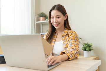 Efficiently preparing packages for seamless shipping. The hands of an online store meticulously...