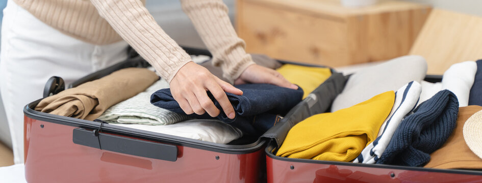 people packing outfit to suitcase for vacation trip - Powered by Adobe