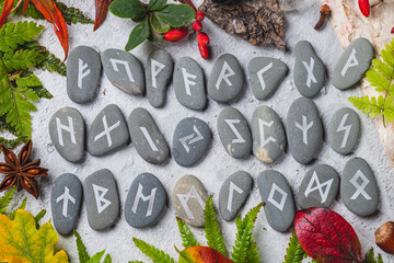 Runes on stones among autumn leaves