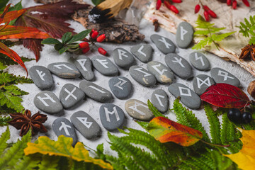 Runes on stones among autumn leaves