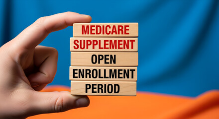 Hand holding wooden blocks spelling medicare supplement open enrollment period concept