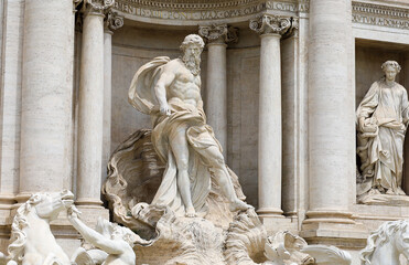 Close up view of the sea god on a shell chariot taming the water statue at the Trevi Fountain in Rome.