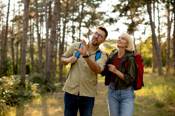 Fototapeta premium Nature walk brings joy to a couple exploring the forest in sunny weather