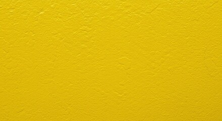 A close-up of a yellow textured wall, showing the rough surface and vibrant color.