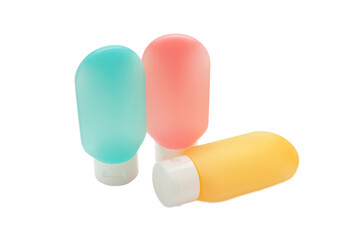 Travel bottles with body care cosmetics isolated on white background.