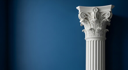White corinthian column against a dark blue wall with copy space to the left.