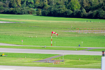 High angle view of runway with windsock at Swiss Airport Zürich Kloten on a late summer day. Photo taken September 15th, 2025, Zurich Kloten, Switzerland.