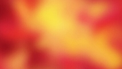 A blurred abstract pattern of warm red and yellow.